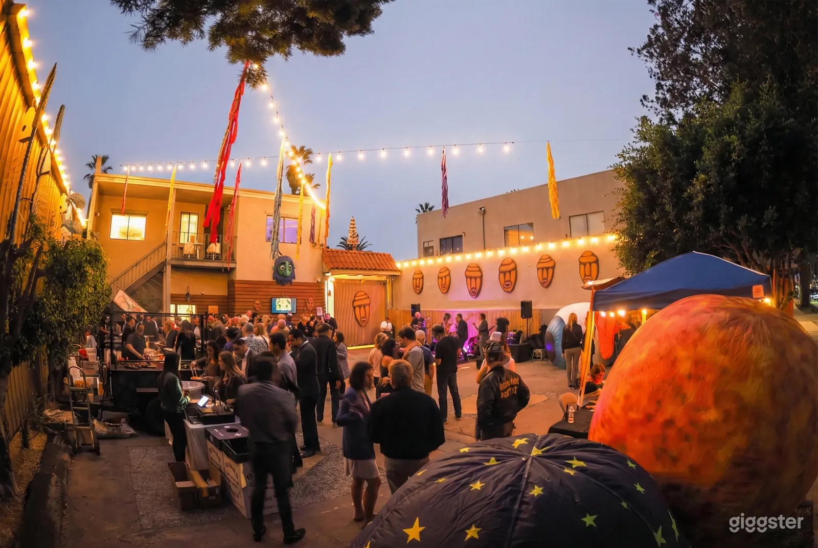 A  holiday venue decorated with string lights and filled with people.