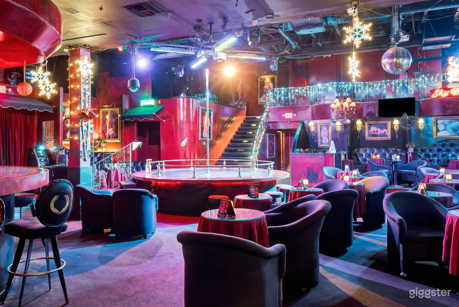 Colors of pink, purple and blue highlight a disco style room filled with tables.