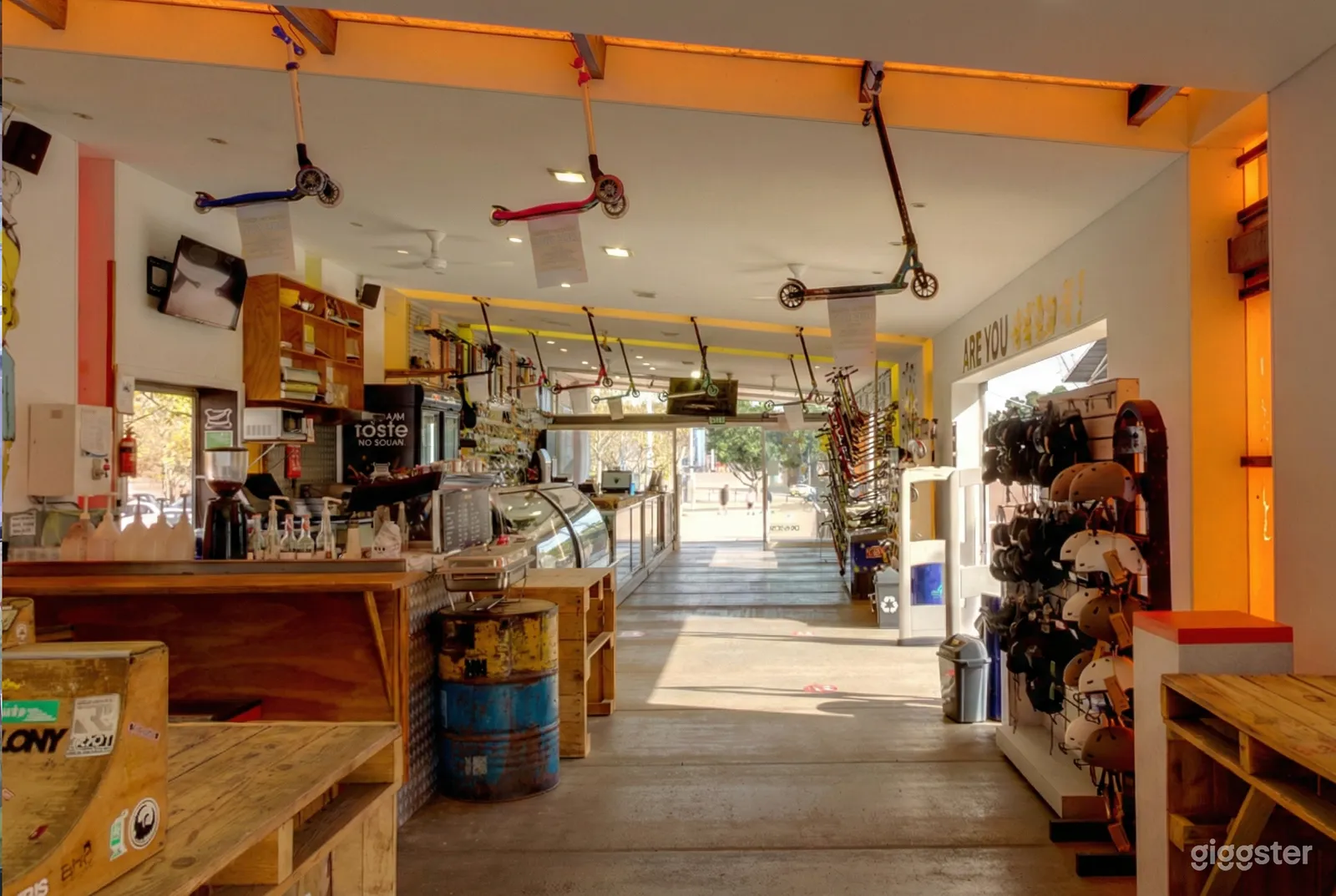 Scooters hang from the ceiling in an open-air scooter shop.