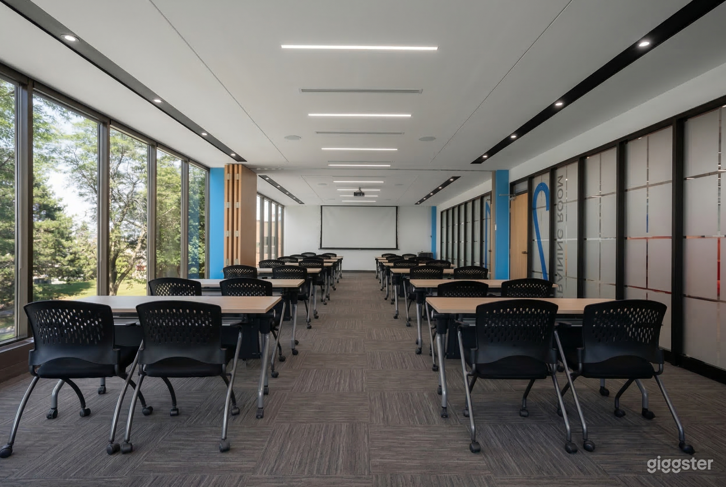 A conference room is filled with tables and chairs facing a whiteboard.