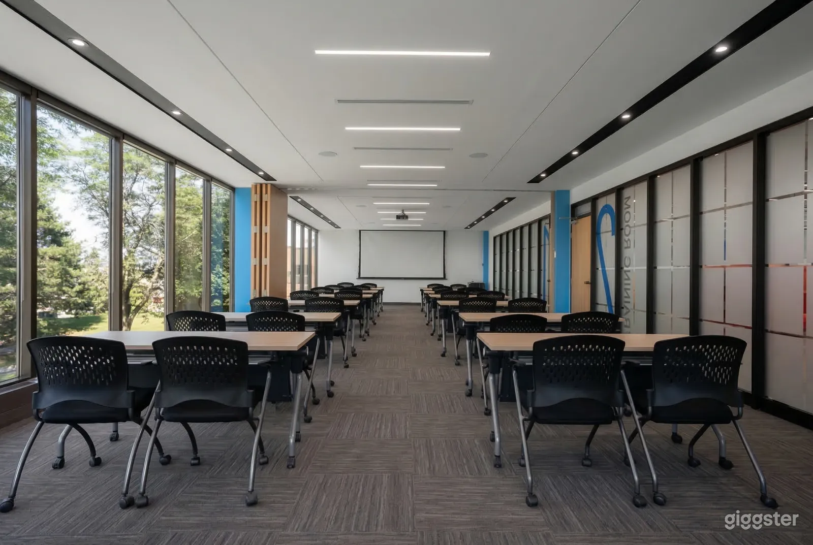 A conference room is filled with tables and chairs facing a whiteboard.