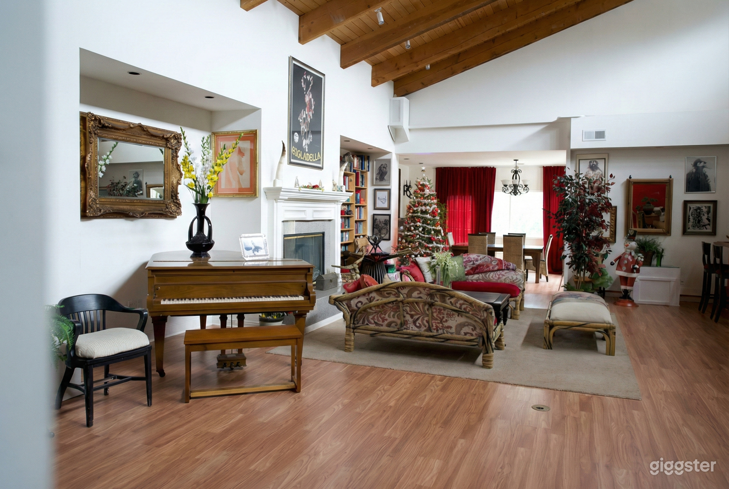A traditionally styled room decorated for the holidays with a Christmas tree in the background.