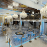 Ballroom decorated in blue and white with large crystal chandeliers as a focal point from the ceiling.