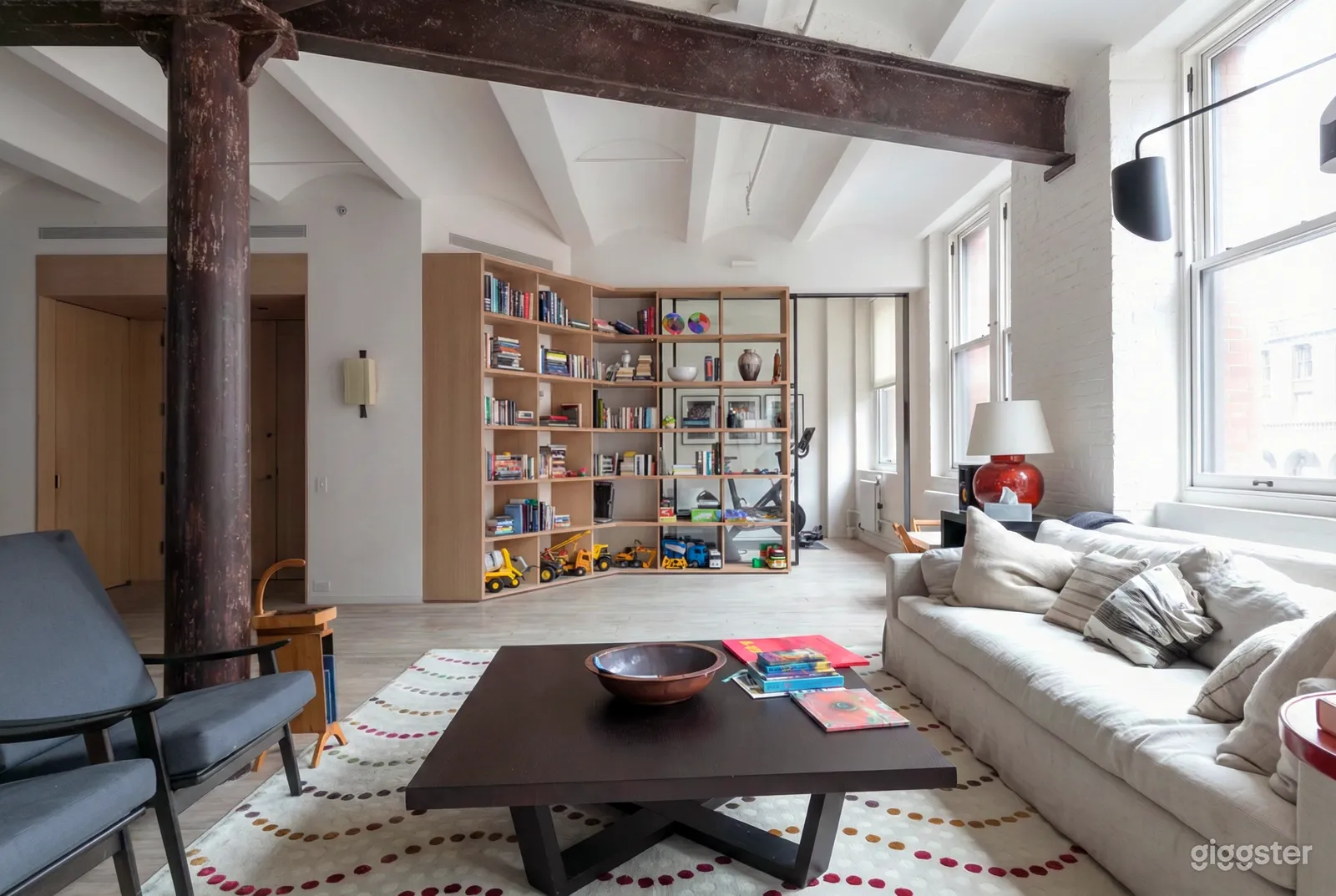 A room with toy-filled shelves ready to host a 1st birthday party.