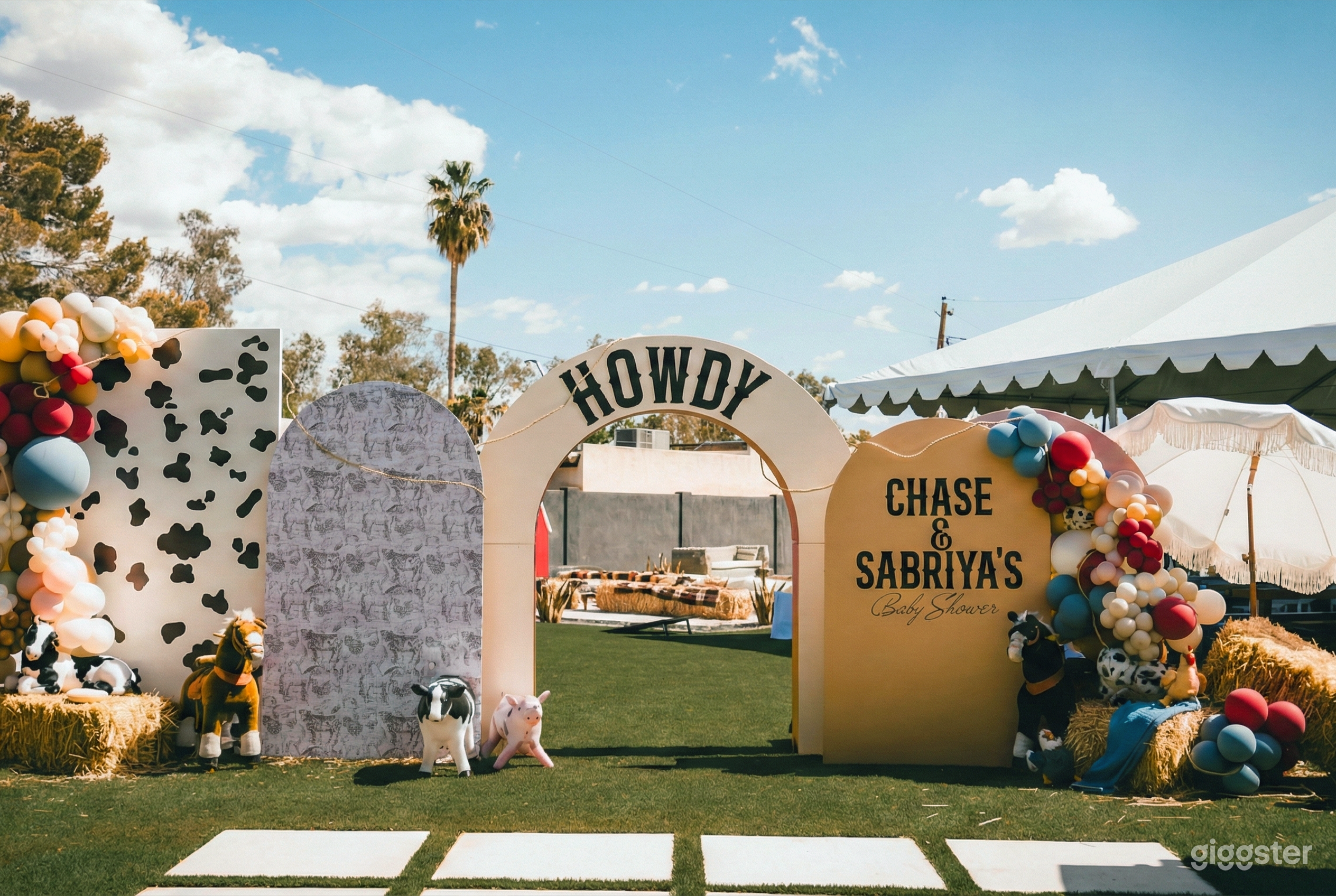 An outdoor space decorated with balloons and toys ready for a 1st birthday party.