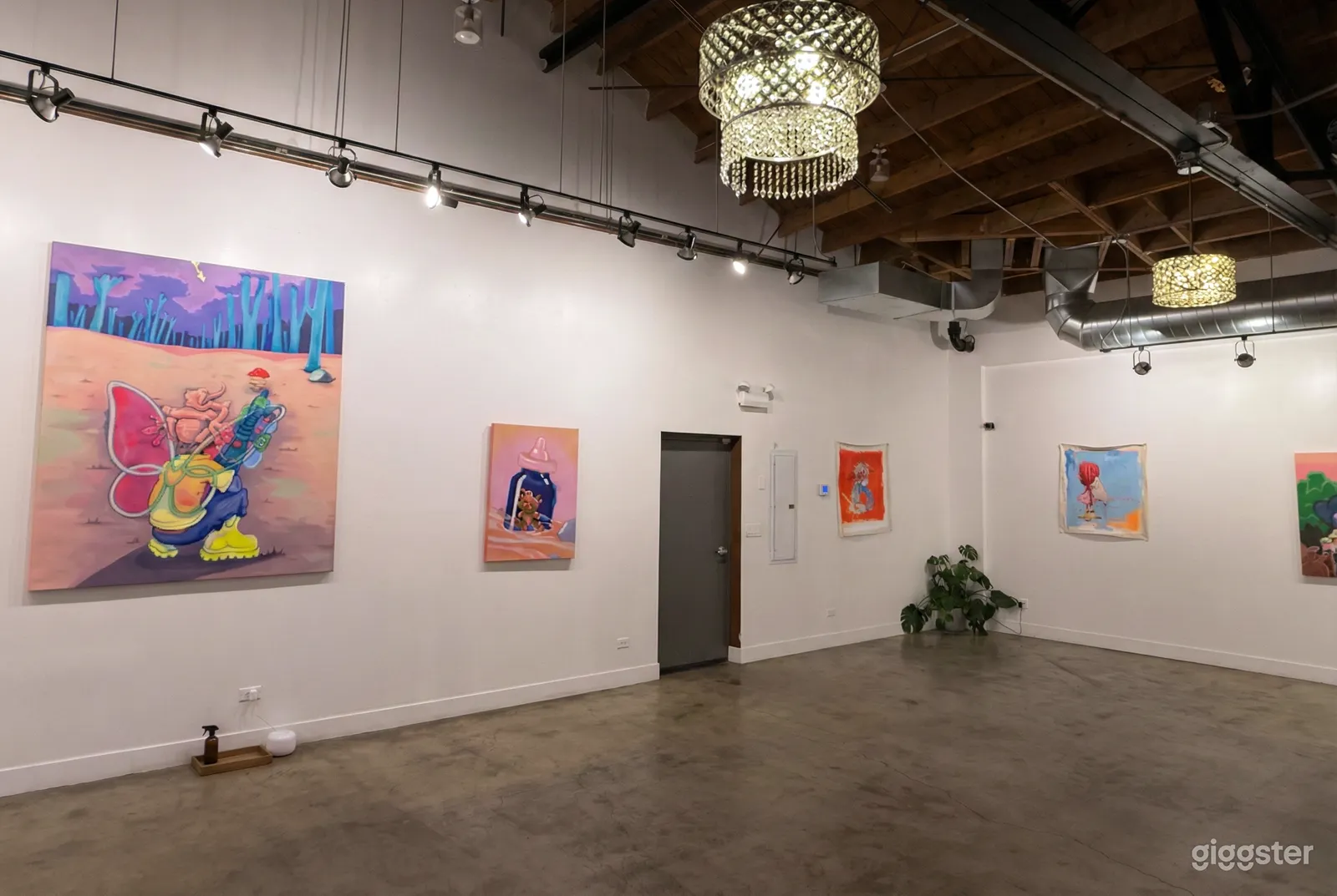 An empty room with posters on the wall and a high ceiling ready for an 18th birthday party.